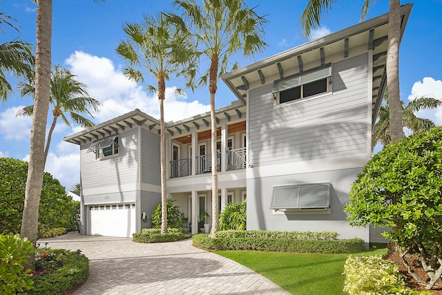 view of front of home with a balcony and a garage