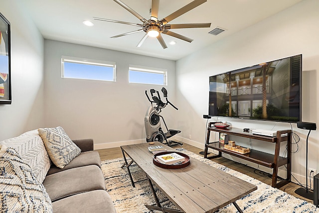 living room with hardwood / wood-style flooring and ceiling fan