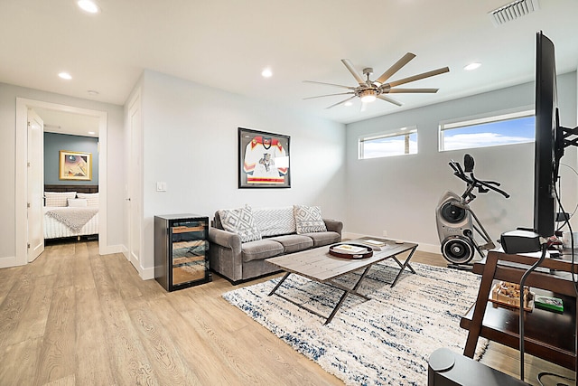 living room featuring light hardwood / wood-style floors and ceiling fan