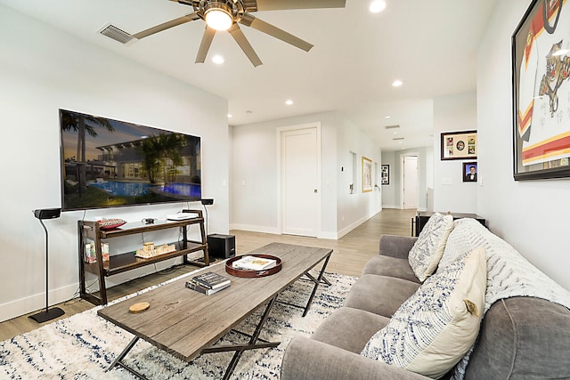 living room with ceiling fan and light hardwood / wood-style floors