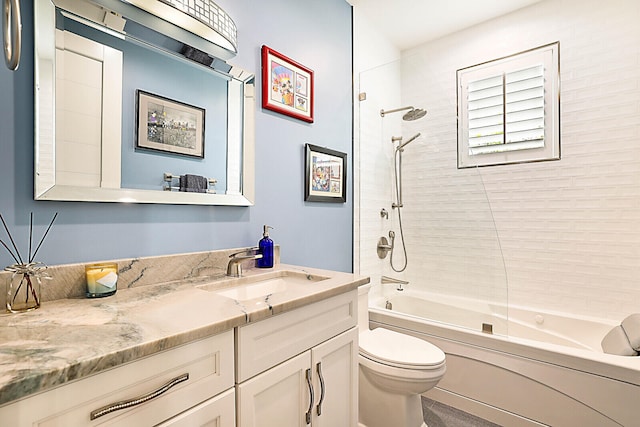 full bathroom featuring toilet, vanity, and tiled shower / bath