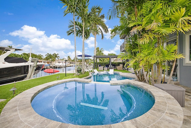 view of swimming pool with a boat dock and a water view