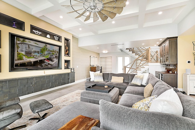 living room with beamed ceiling, ceiling fan, and coffered ceiling