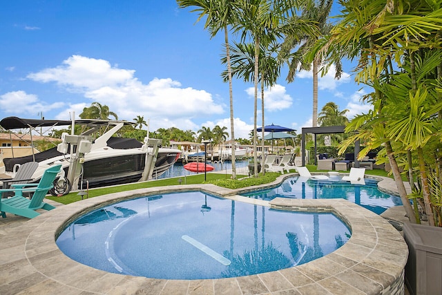 view of swimming pool featuring a water view and a dock