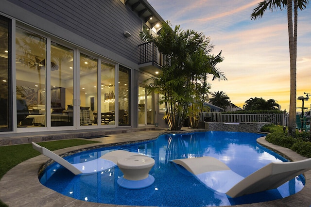 view of pool at dusk