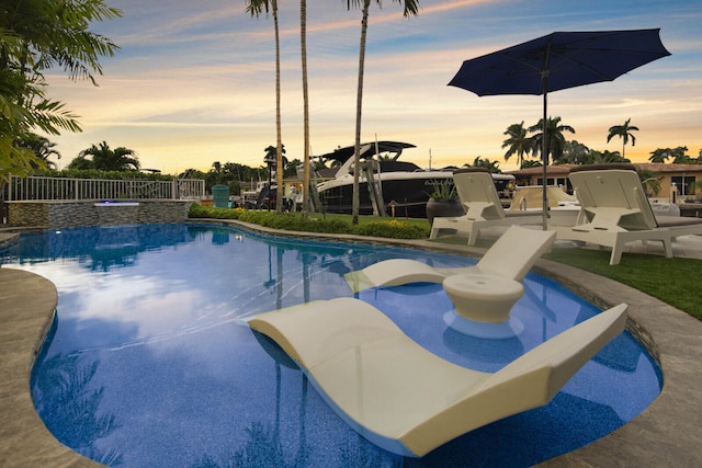 view of pool at dusk