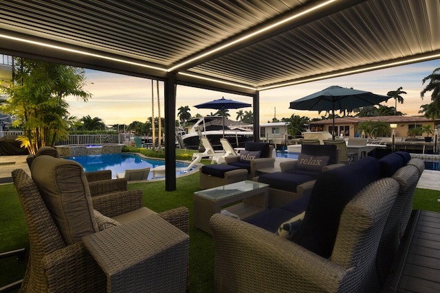 patio terrace at dusk featuring an outdoor living space