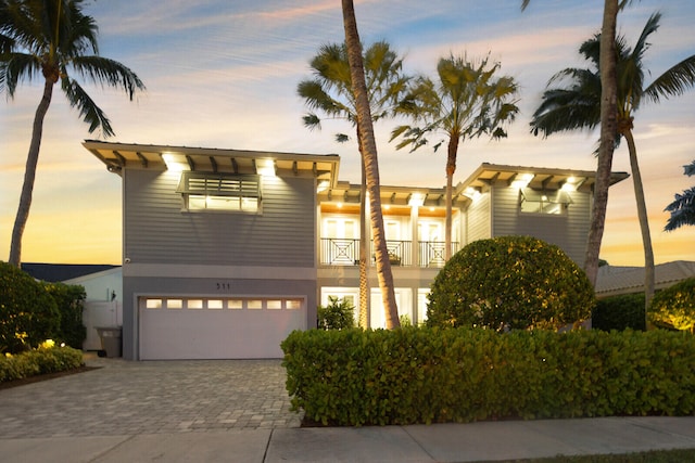 view of front of home with a balcony and a garage