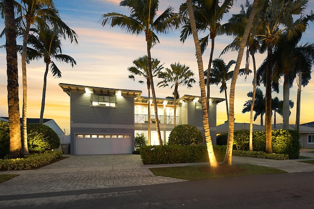 view of front of home with a balcony and a garage