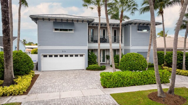 view of front of house featuring a garage and a balcony