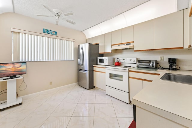 kitchen with white appliances, vaulted ceiling, ceiling fan, and sink