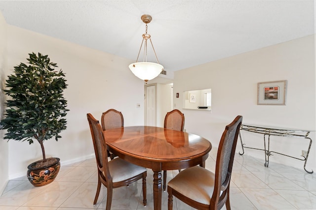 dining space featuring a textured ceiling