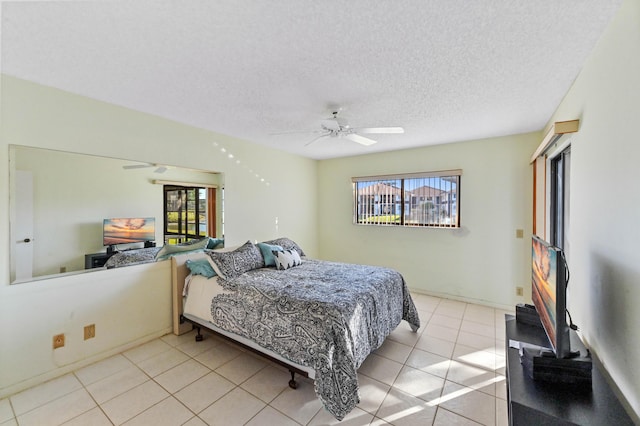 bedroom with light tile patterned floors, a textured ceiling, and ceiling fan