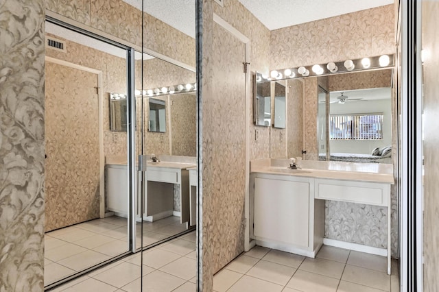 bathroom featuring vanity, a textured ceiling, tile patterned floors, and ceiling fan