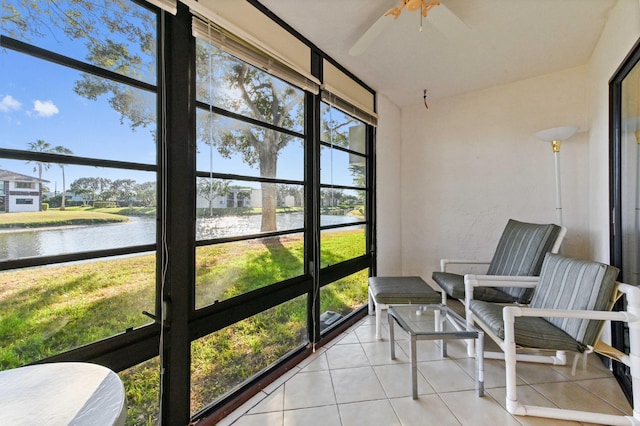 sunroom / solarium with a water view and ceiling fan