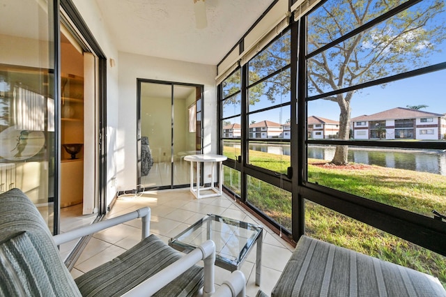 sunroom / solarium featuring a water view