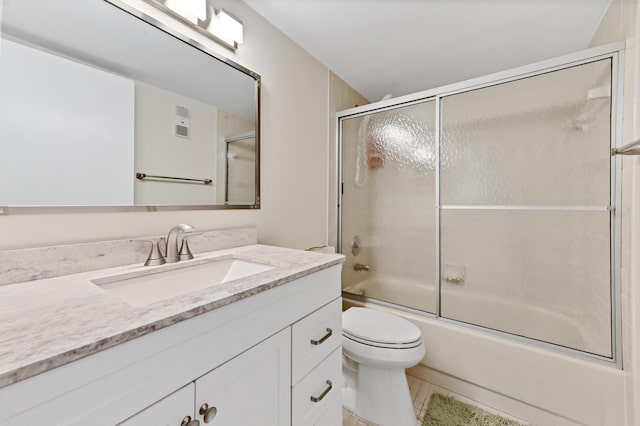 full bathroom featuring tile patterned flooring, vanity, enclosed tub / shower combo, and toilet