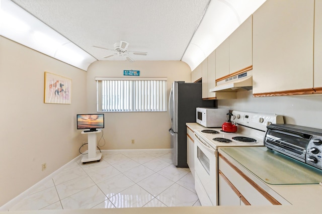 kitchen featuring white appliances, vaulted ceiling, ceiling fan, a textured ceiling, and cream cabinetry