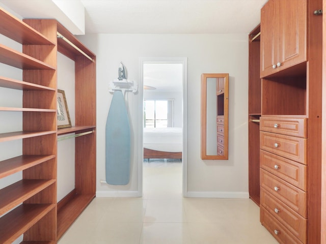 spacious closet featuring light tile patterned floors