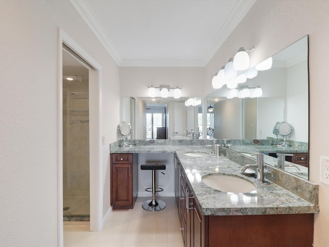 bathroom featuring tiled shower, vanity, tile patterned floors, and crown molding