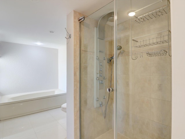 bathroom with tile patterned flooring, toilet, and a shower with door