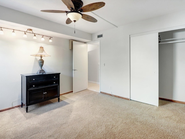 carpeted bedroom featuring ceiling fan and a closet