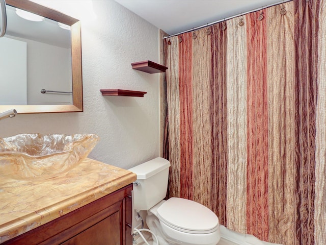 bathroom featuring vanity, a shower with shower curtain, and toilet