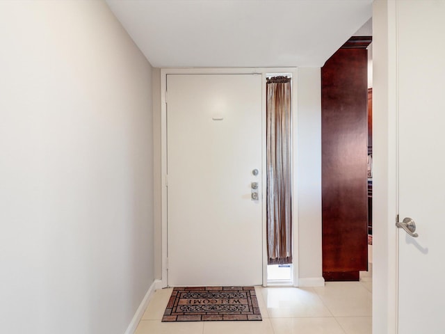 doorway with light tile patterned floors