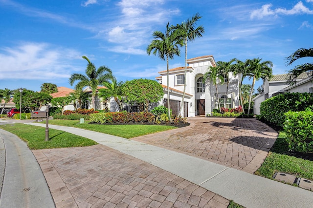 mediterranean / spanish home featuring a front lawn