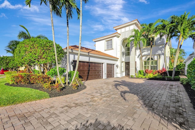 mediterranean / spanish house featuring a garage