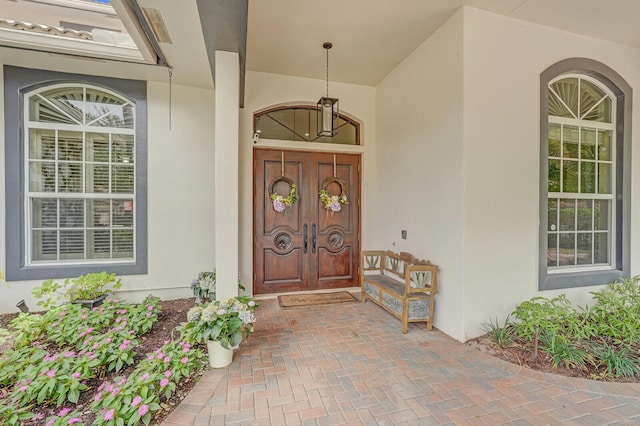 view of exterior entry featuring covered porch