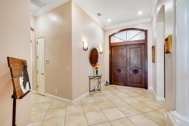 entrance foyer featuring light tile patterned flooring and ornamental molding