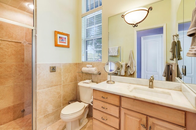 bathroom with vanity, toilet, an enclosed shower, and tile walls