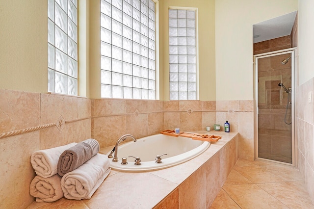 bathroom featuring tile patterned flooring and shower with separate bathtub