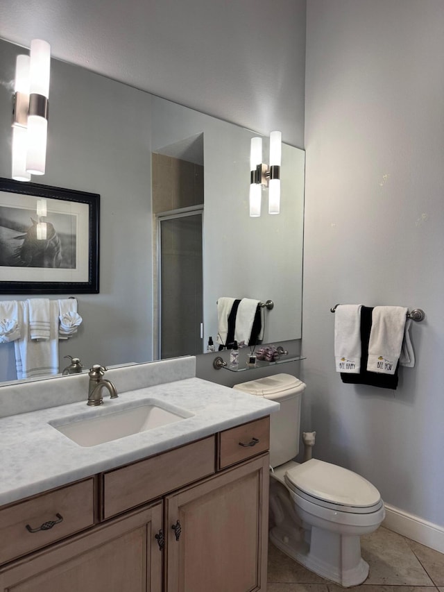 bathroom with toilet, tile patterned flooring, vanity, and walk in shower