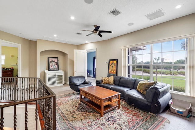 living room featuring ceiling fan and light hardwood / wood-style flooring