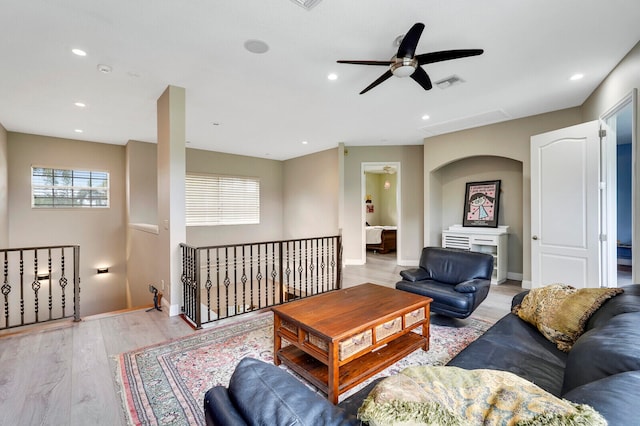 living room with ceiling fan and light wood-type flooring