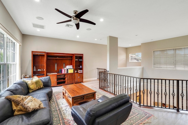 living room with ceiling fan and light wood-type flooring