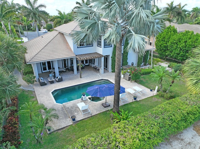 view of swimming pool featuring a patio area, a yard, and an outdoor hangout area