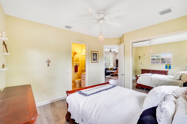 bedroom with a closet, connected bathroom, light hardwood / wood-style floors, and ceiling fan