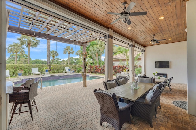 view of patio featuring a pergola, a fenced in pool, and ceiling fan