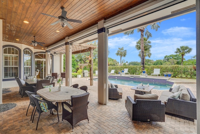 view of patio / terrace featuring an outdoor living space, a fenced in pool, and ceiling fan