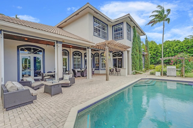 rear view of house with french doors, an outdoor hangout area, a pergola, ceiling fan, and a patio