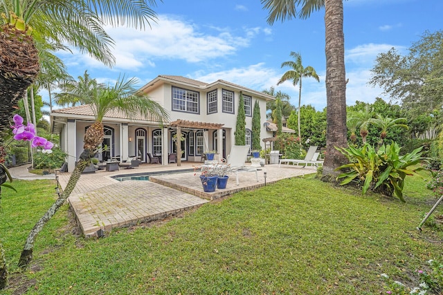 rear view of property featuring a yard, a pergola, an outdoor living space, and a patio area