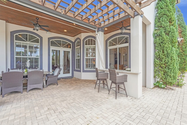 view of patio / terrace with a pergola, ceiling fan, french doors, and exterior bar