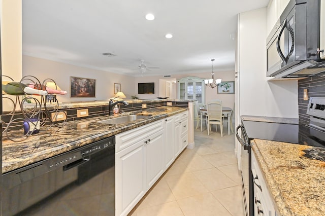 kitchen with white cabinets, sink, dark stone countertops, and black appliances