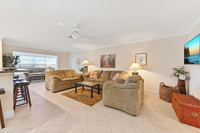 tiled living room with ceiling fan and crown molding