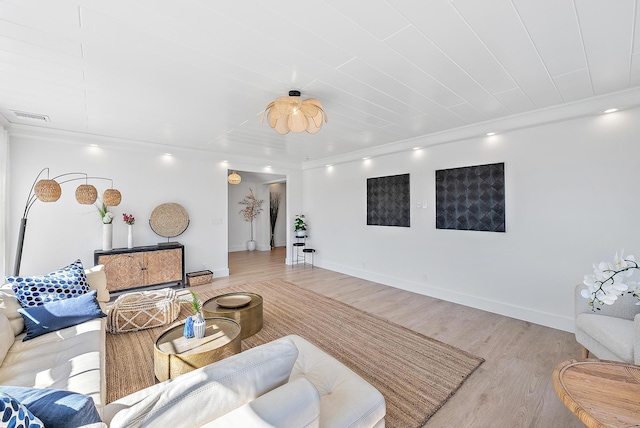 living room with light hardwood / wood-style flooring and ornamental molding