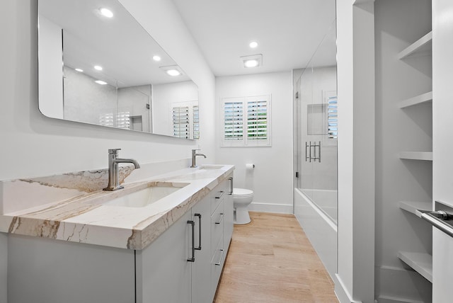 bathroom featuring hardwood / wood-style flooring, vanity, and toilet