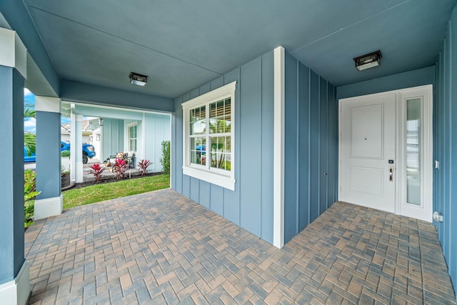 view of exterior entry with covered porch